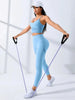 Model demonstrating a two-piece women's fitness outfit, featuring high-waist leggings and a stretch sports bra.